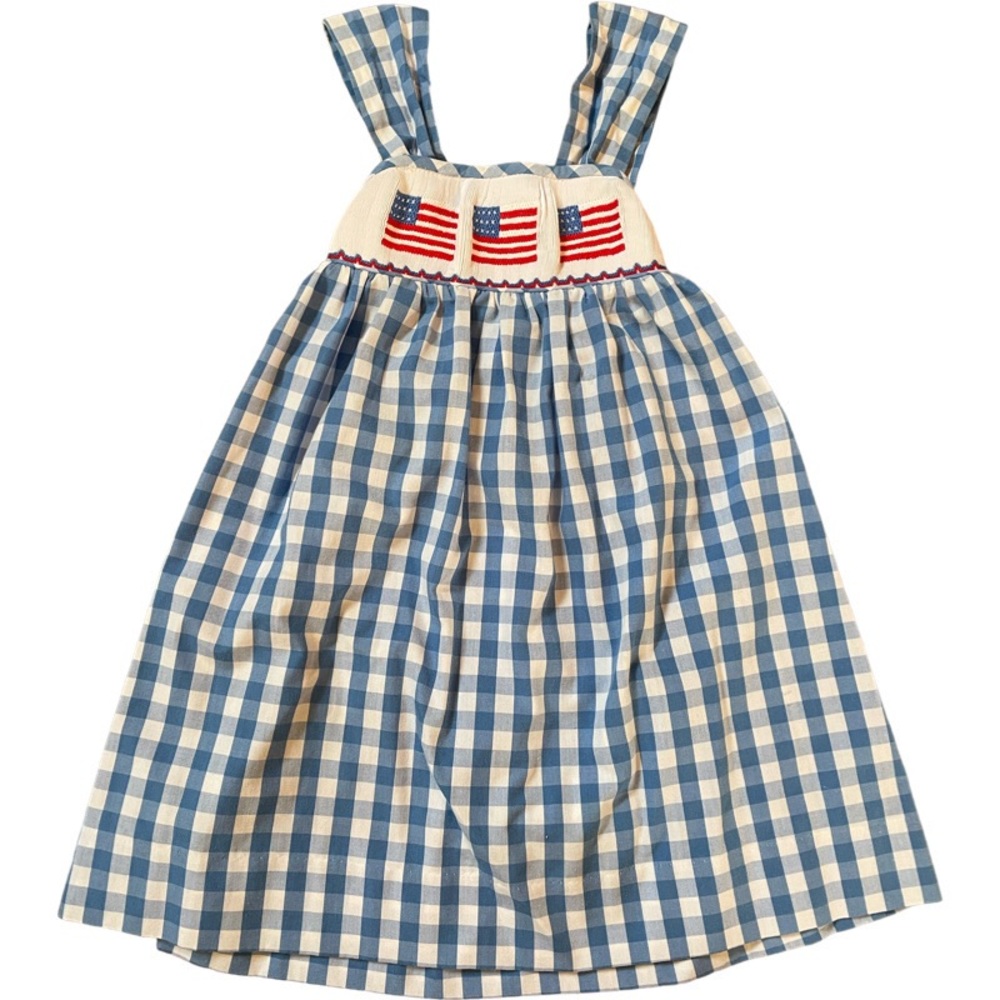 Smocked blue gingham dress with flags. Bow in back to adjust length. EUC.
